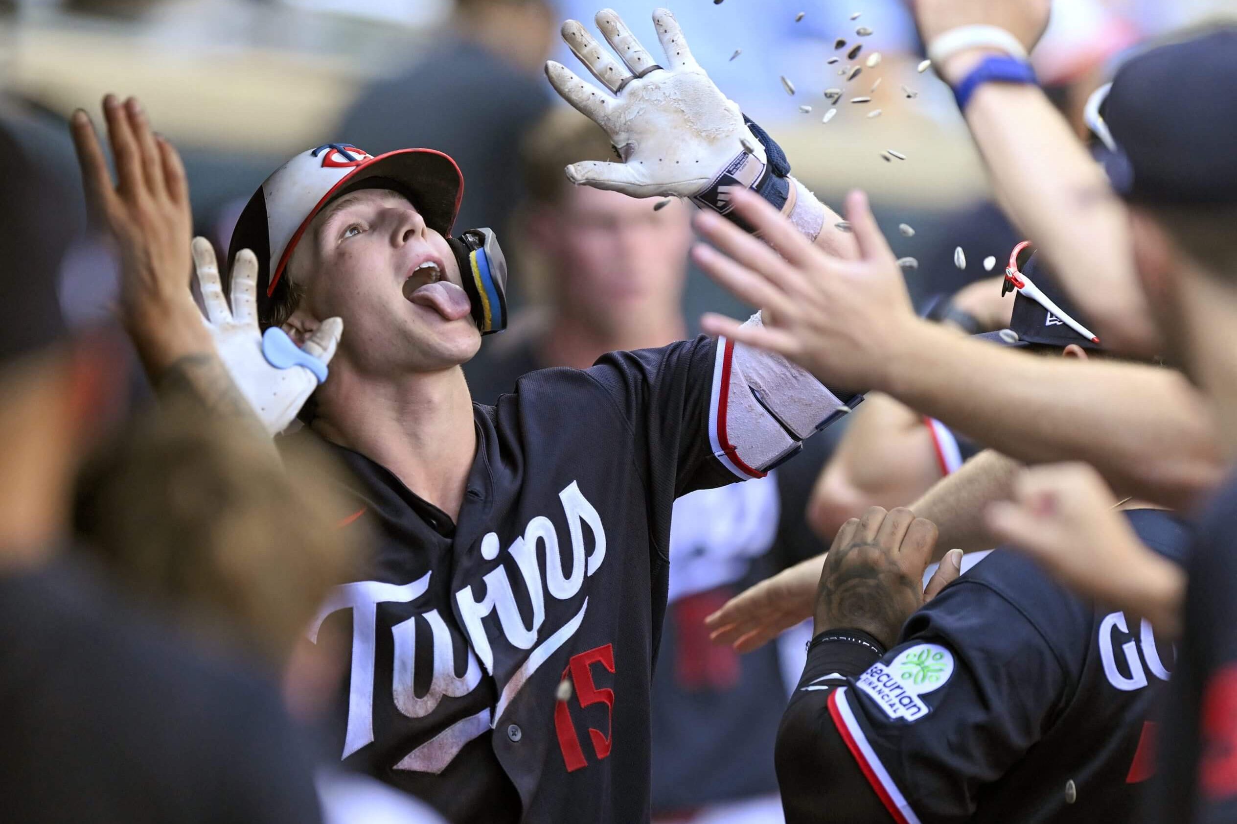 Minnesota Twins infielder Luke Keaschall celebrates his solo home run against the Chicago White Sox but trying to catch sunflower seeds in his mouth.