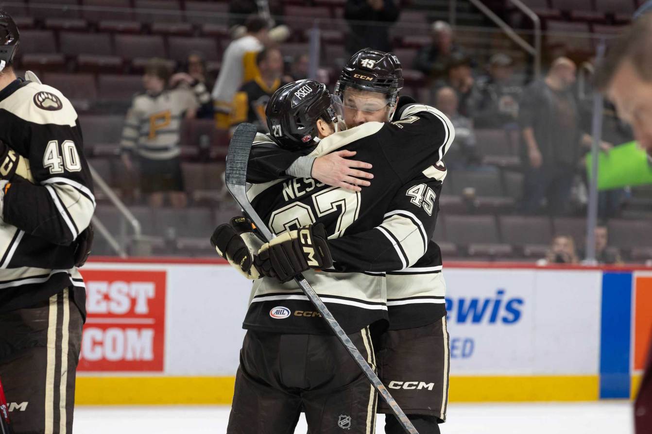 Matt Strome hugs Aaron Ness
