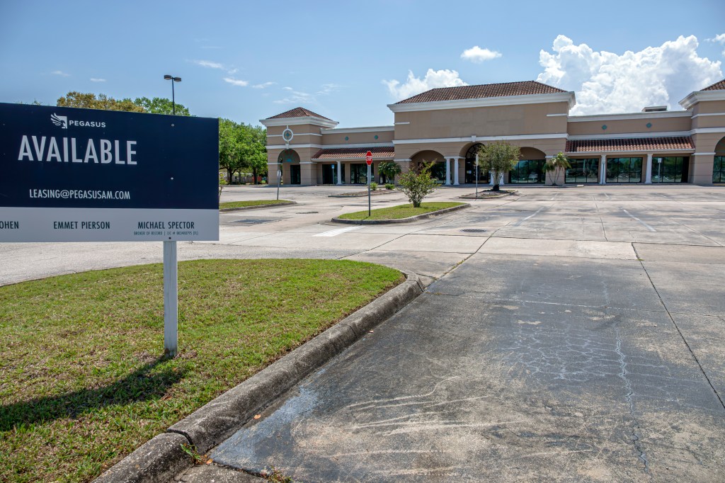 A commercial retail building with a "Pegasus Available for Lease" sign in Melbourne, Florida.