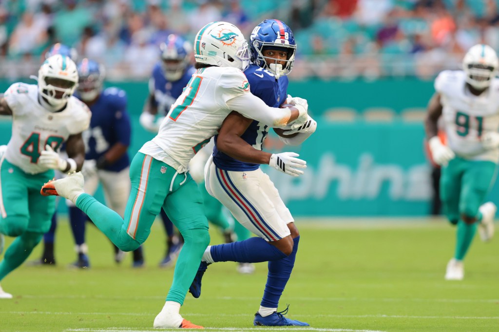 Darius Slayton of the New York Giants is tackled by Marco Wilson of the Miami Dolphins.