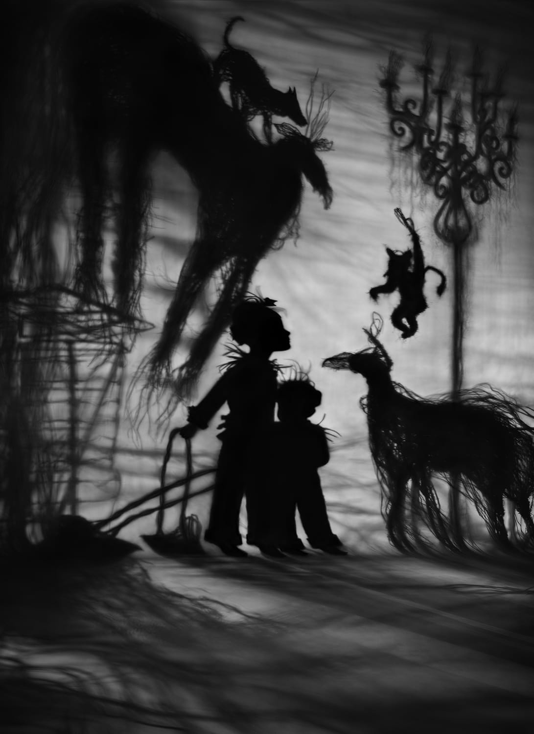 a black-and-white photograph by Susan kae Grant of a silhouetted dream-like scene with two young boys and a number of animals