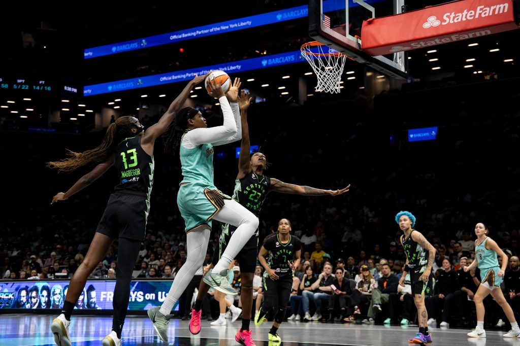 Jonquel Jones (35) of the New York Liberty shoots the ball over Jordan Horston (23) of the Seattle Storm.