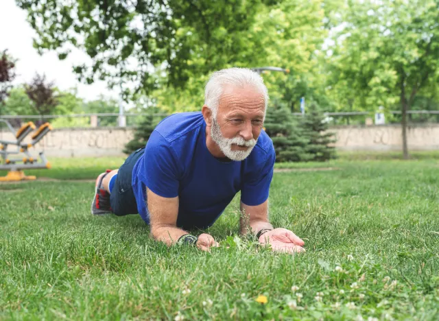 senior man planks exercise, demonstrates worst weight loss exercises