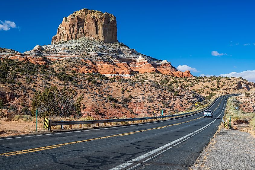 Desert highway cutting through red rock country in northern Arizona.
