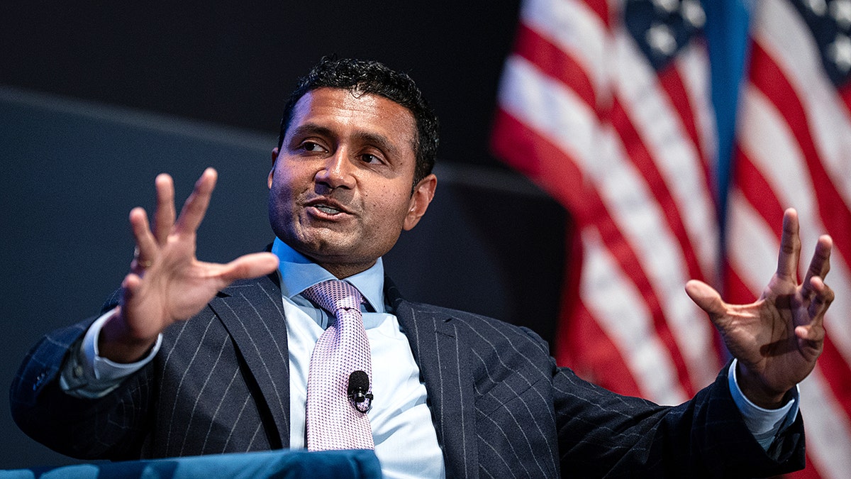 Shyam Sankar speaking at a podium during a forum event.
