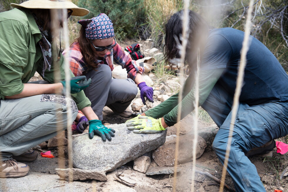 Volunteers move rocks to provide erosion control on Mount Lemmon