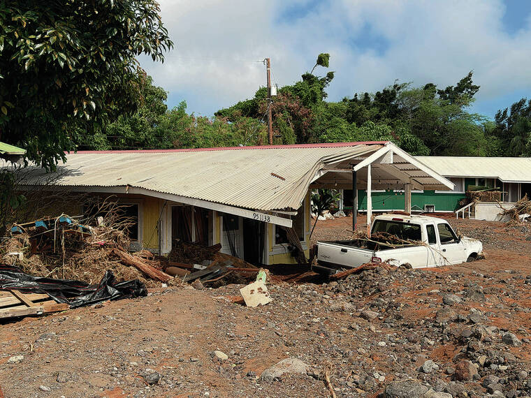 VICTORIA BUDIONO / STAR-ADVERTISER
President Donald Trump approved a federal disaster declaration today for Hawaii island in the aftermath of Hurricane Lala. On Thursday, nearly a week after the hurricane pummeled the Kau district, a home and truck in Naalehu remained buried in mud and rocks from massive flooding in the area.