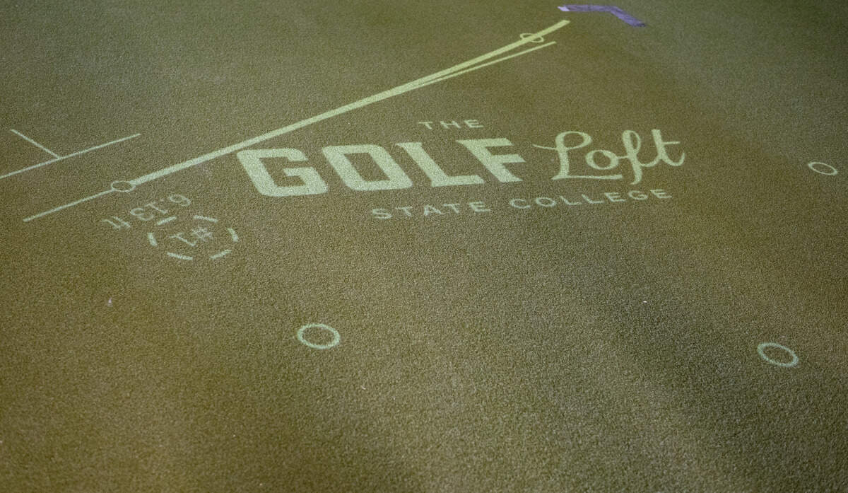 A PuttView putting green in the lobby of The Golf Loft on Wednesday, Sept. 2, 2026. The system uses an overhead projector to show putting paths.