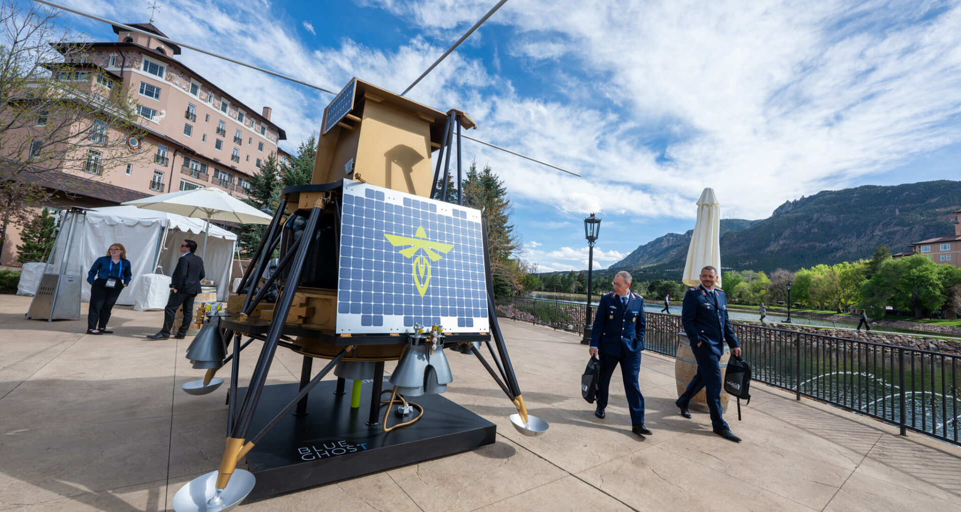 Officers from the German Air Force check out the Firefly Aerospace's Blue Ghost that is on display at the 41st Space Foundation Space Symposium at the Broadmoor Hotel on Monday, April 13, 2026. The commercial lunar lander is designed for transporting payloads to the Moon's surface. The craft achieved a soft landing on the moon in 2025, carrying ten payloads for NASA.