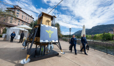 Officers from the German Air Force check out the Firefly Aerospace's Blue Ghost that is on display at the 41st Space Foundation Space Symposium at the Broadmoor Hotel on Monday, April 13, 2026. The commercial lunar lander is designed for transporting payloads to the Moon's surface. The craft achieved a soft landing on the moon in 2025, carrying ten payloads for NASA.