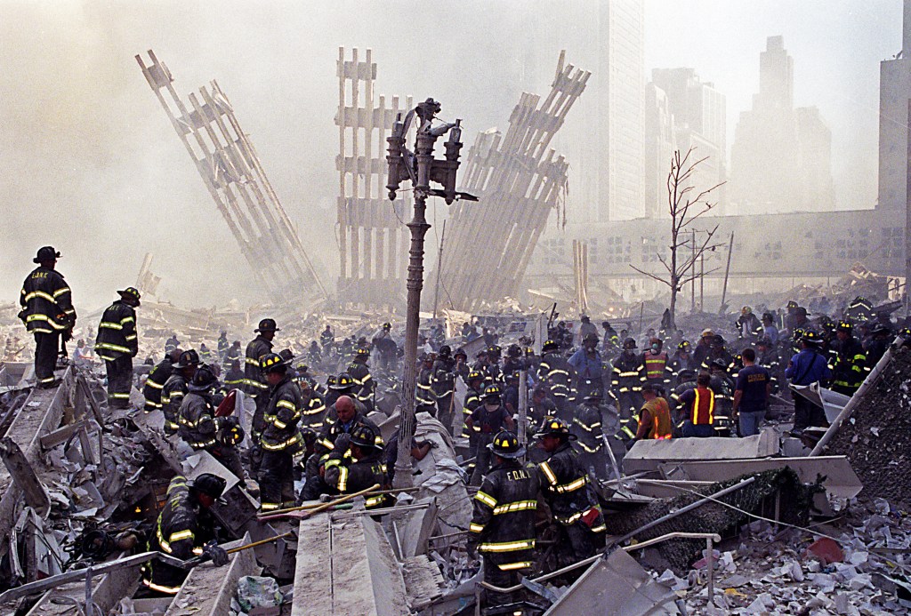 Emergency responders working amid the rubble and smoke of the World Trade Center attacks.