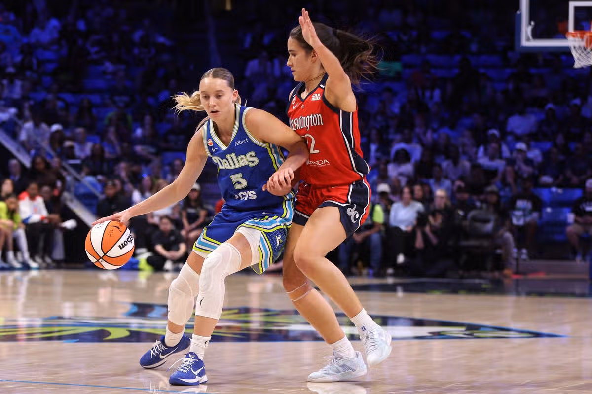 Paige Bueckers is defended by Sonia Citron during a WNBA game