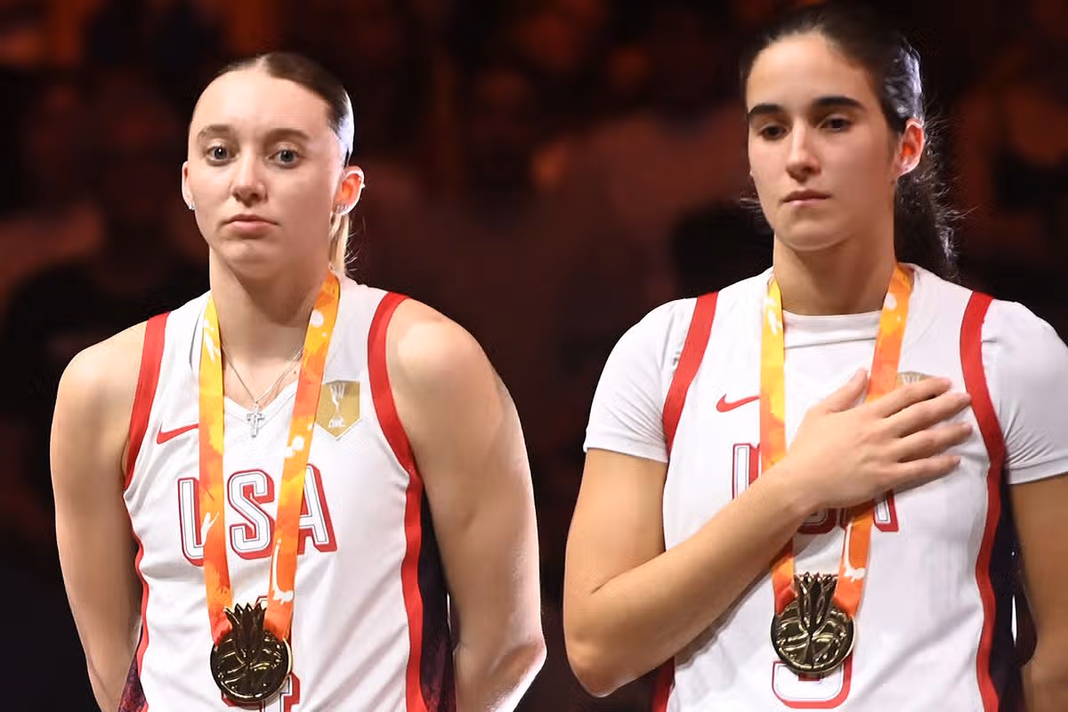 Paige Bueckers and Sonia Citron stand for the national anthem