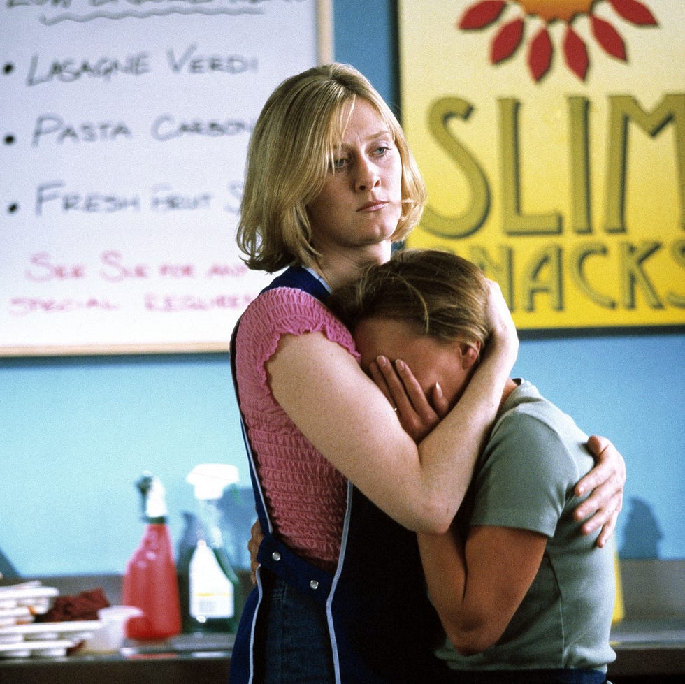 woman comforting another person in a snack shop. woman comforting another person in a snack shop.