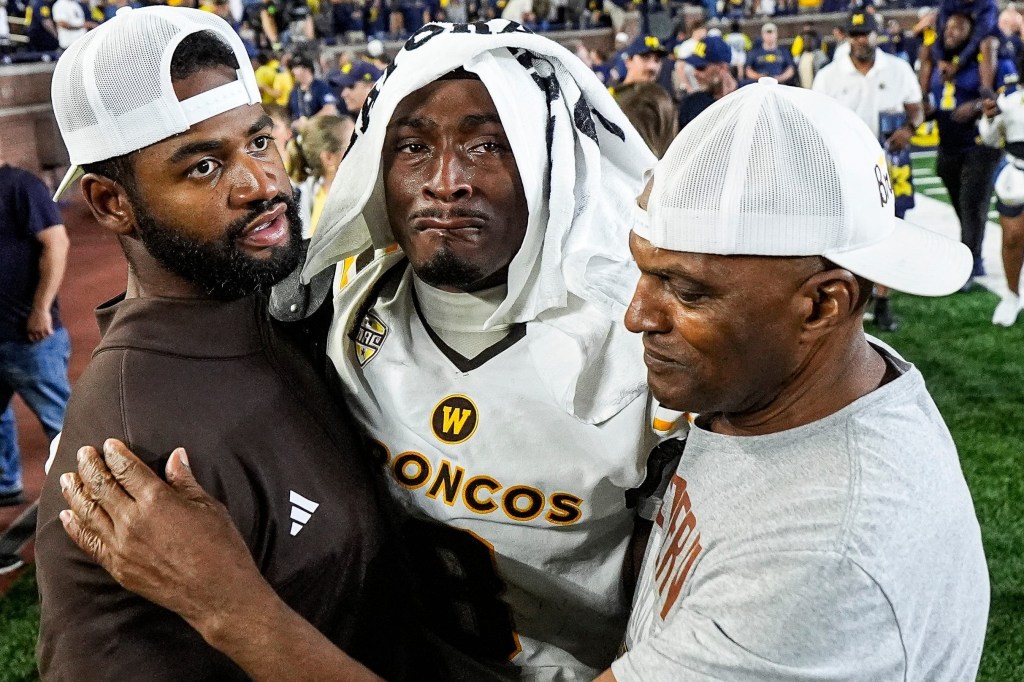 Western Michigan coaches comfort cornerback Jarvarius Sims (8) after a 13-12 loss to Michigan at Michigan Stadium in Ann Arbor, Sunday, Sept. 6, 2026.