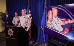 LAS VEGAS, NEVADA - SEPTEMBER 29: An image on a television monitor shows a photo of Tupac Shakur (L) and Marion "Suge" Knight Jr. in a car in Las Vegas the night Shakur was killed as (L-R) Clark County District Attorney Steve Wolfson, Clark County Sheriff Kevin McMahill and Las Vegas Metropolitan Police Department Lt. Jason Johansson hold a news conference at the LVMPD headquarters on the arrest and indictment of Duane "Keefe D" Davis for the 1996 murder of Shakur on September 29, 2023 in Las Vegas, Nevada. A Nevada grand jury indicted Davis on one count of murder with a deadly weapon in the fatal drive-by shooting of rapper Tupac Shakur. (Photo by Ethan Miller/Getty Images)
