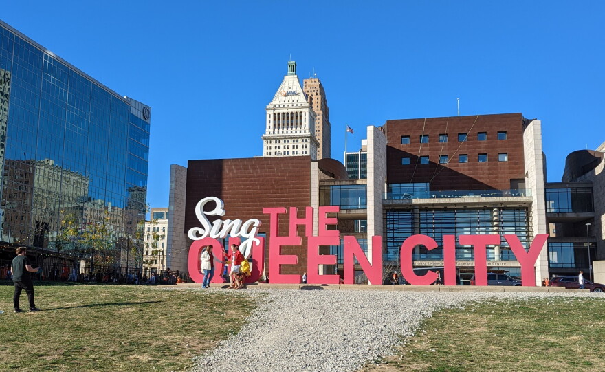 Big letters spell out "Sing the Queen City" in front of the National Underground Railroad Freedom Center.