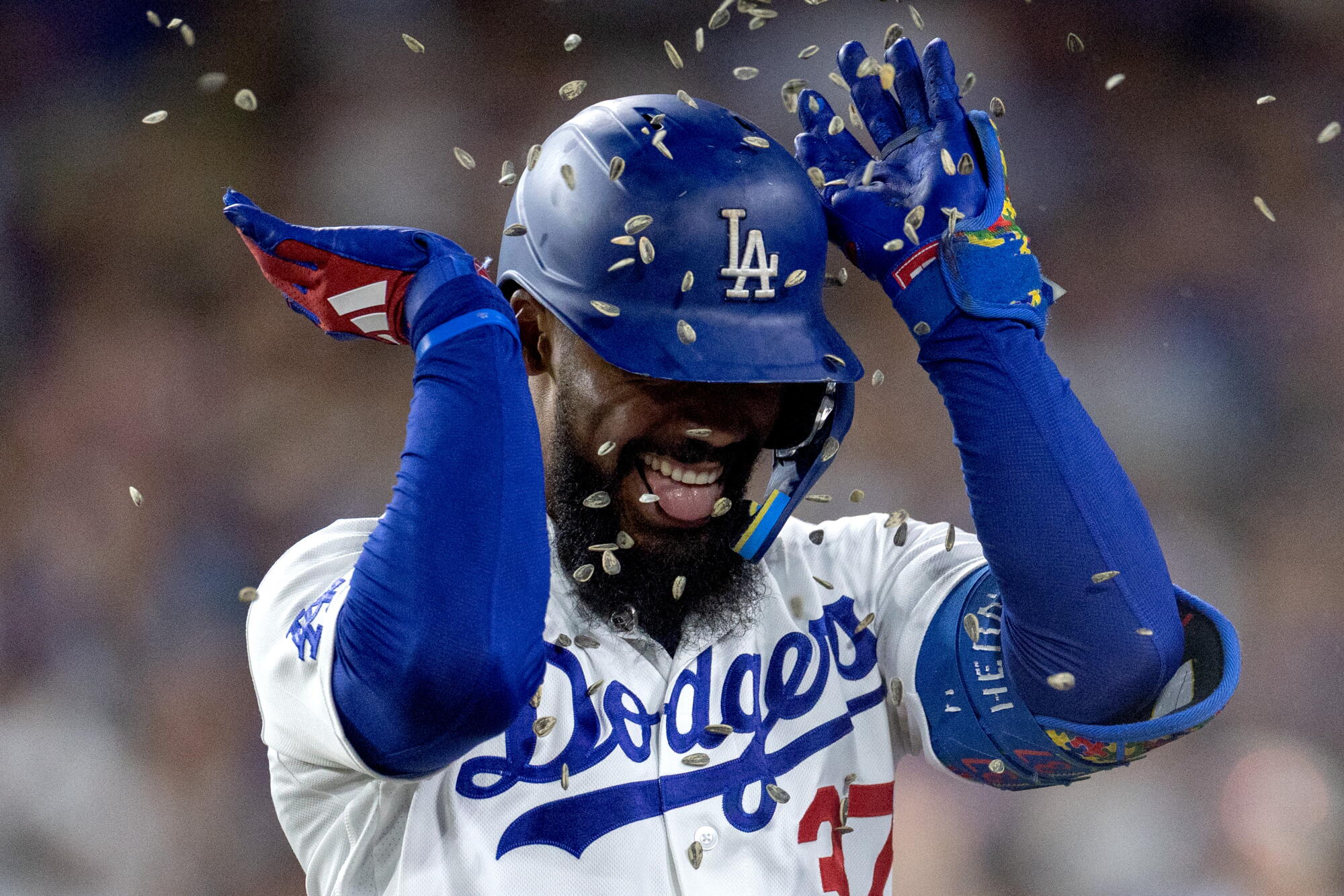 Teoscar Hernandez is showered with sunflower seeds after hitting a three-run home run in the sixth inning.