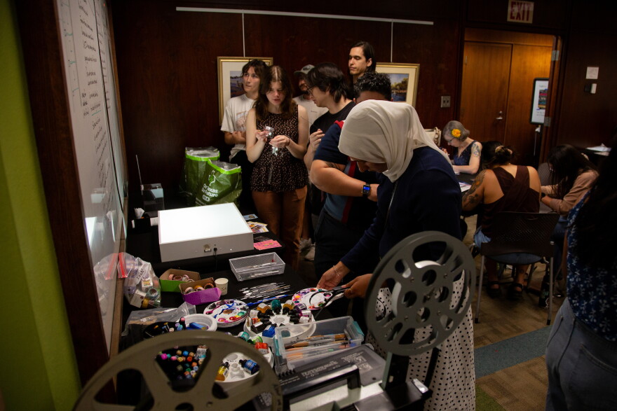 Patrons gather supplies at the Film Strip Club meeting at the Howson Branch Library on Monday, August 10, 2026. Ysa Mendoza/KUT