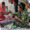 Thirteen-month-old Jannat cries as her mother Sohana, a garment worker, tries to feed her. The child is hospitalized for measles at DNCC Hospital in Dhaka, Bangladesh.