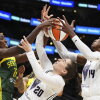 Golden State Valkyries guard Kate Martin (20) struggles to maintain possession against Seattle Storm forward Ezi Magbegor (left) as Valkyries center Temi Fagbenle (14) reaches for the ball during the second half of a WNBA game Wednesday in Seattle. The Valkyries debuted this season as the league's 13th team.