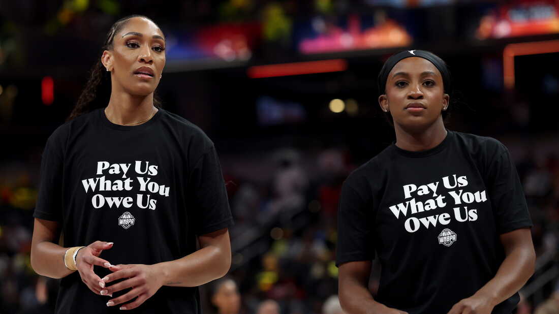 A’ja Wilson, left, and Jackie Young of the Las Vegas Aces wear shirts saying "Pay us what you owe us" prior to the 2025 WNBA All-Star Game in Indianapolis, Ind.
