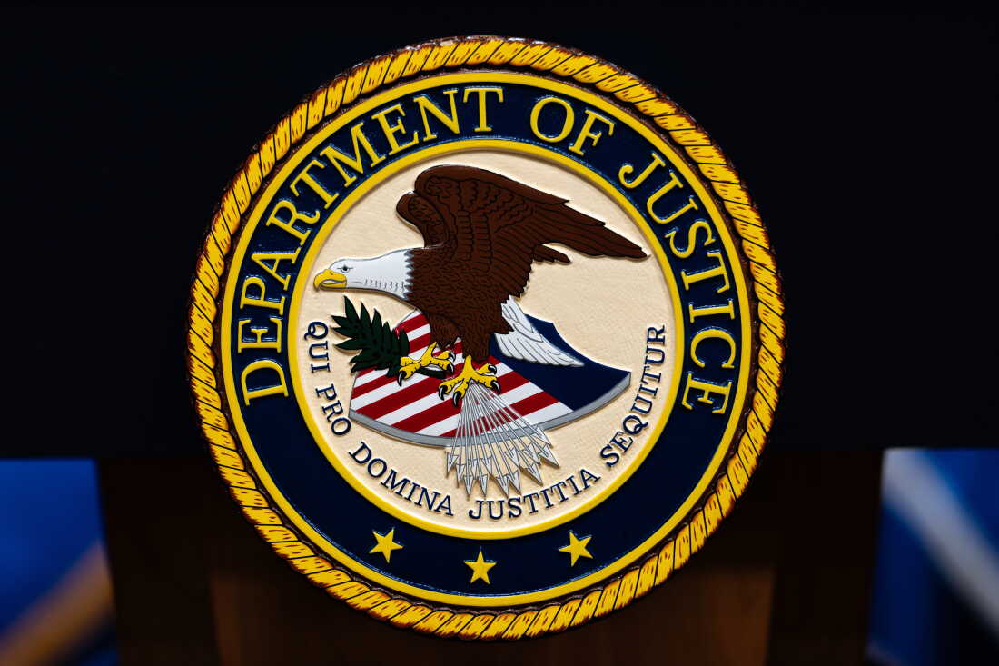 FILE - The U.S. Department of Justice logo is seen on a podium before a news conference, May 4, 2026, in Washington.