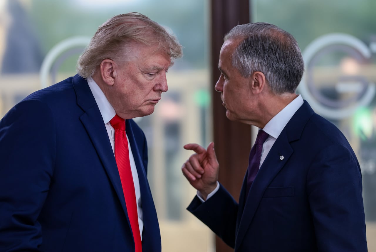 President Donald Trump speaks with Canadian Prime Minister Mark Carney, right, at a working lunch with leaders of G7 and the Middle East in Evian-les-Bains, France
