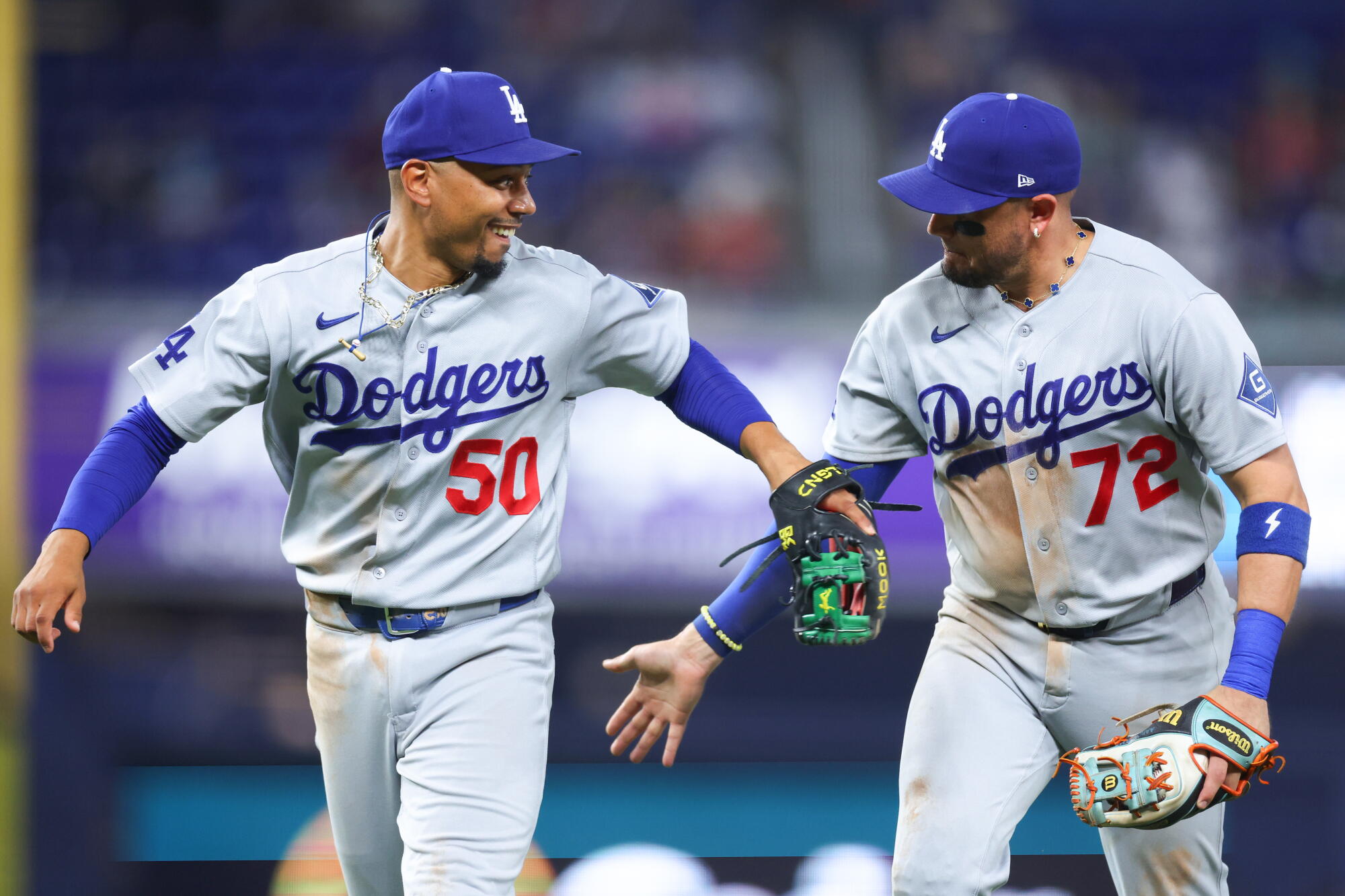 Dodgers' Mookie Betts, left, and Miguel Rojas celebrate in the seventh inning against the Marlins in Miami on Sunday.