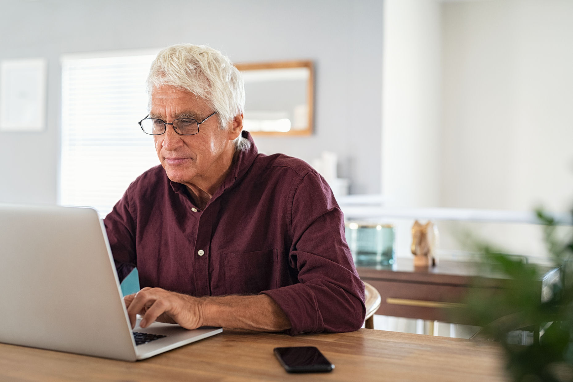 Person sitting at a desk and using a laptop.