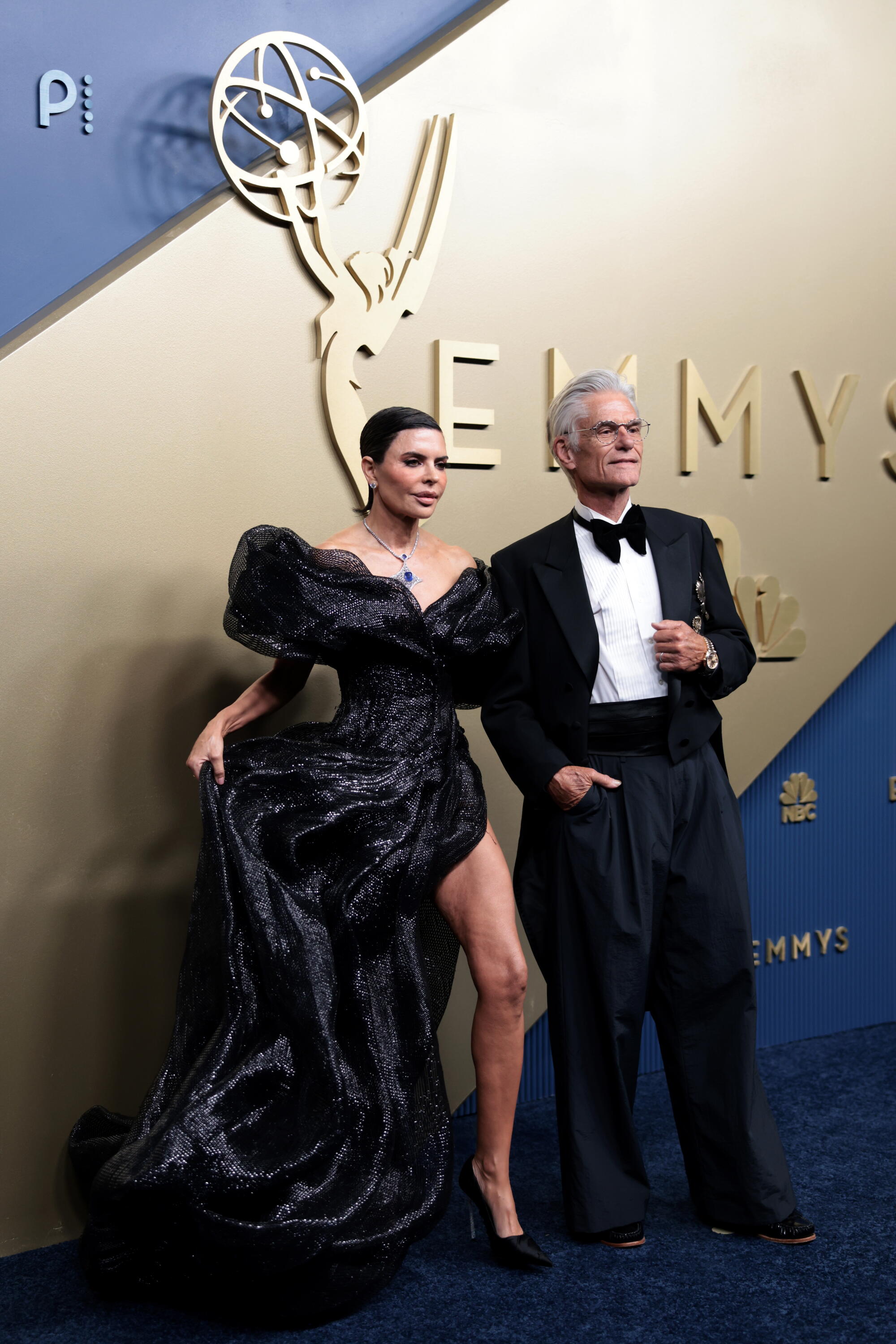 Lisa Rinna and Harry Hamlin pose on the Emmys blue carpet. 