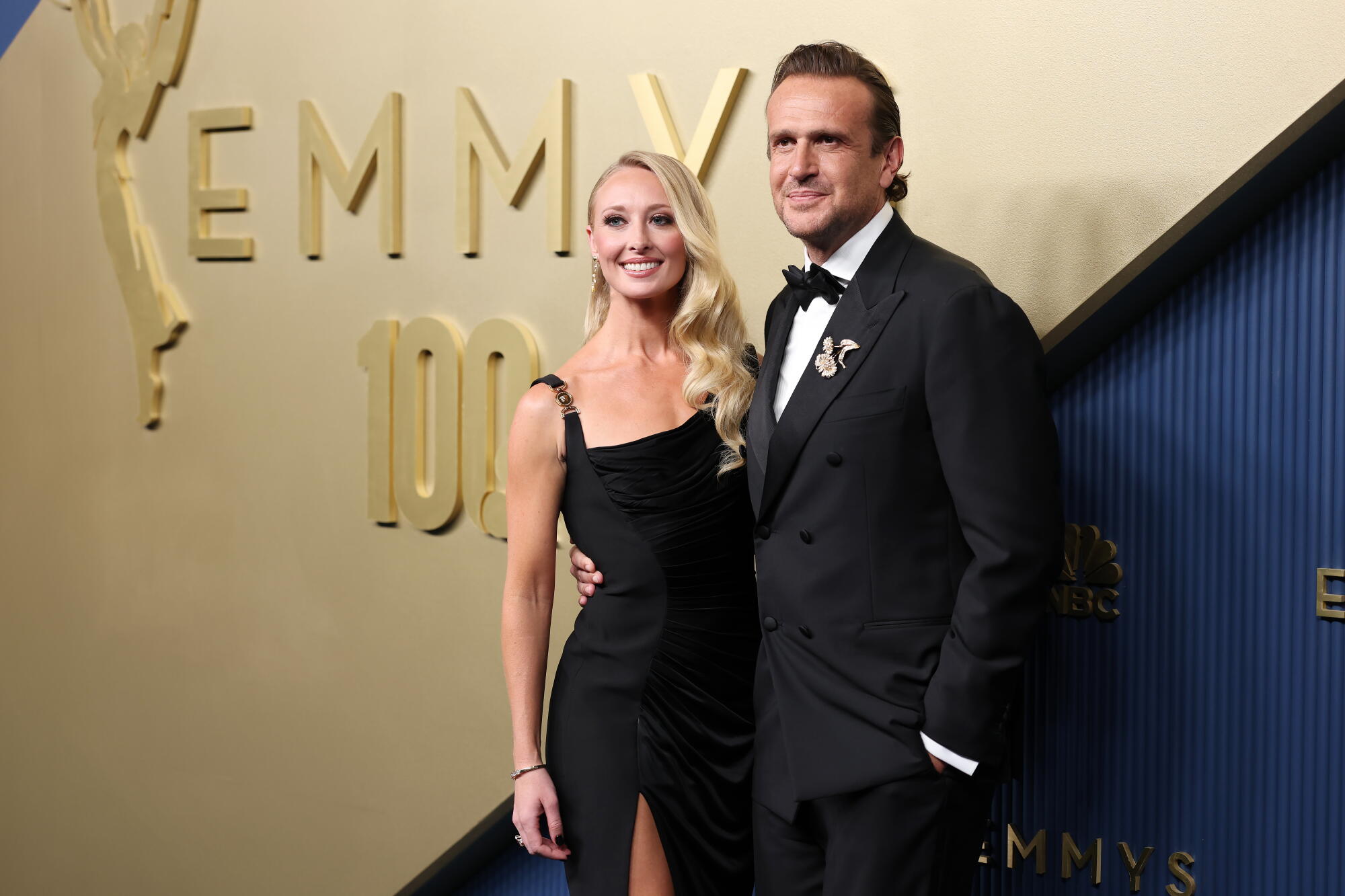 Kayla Radomski and Jason Segel pose on the Emmys red carpet. 