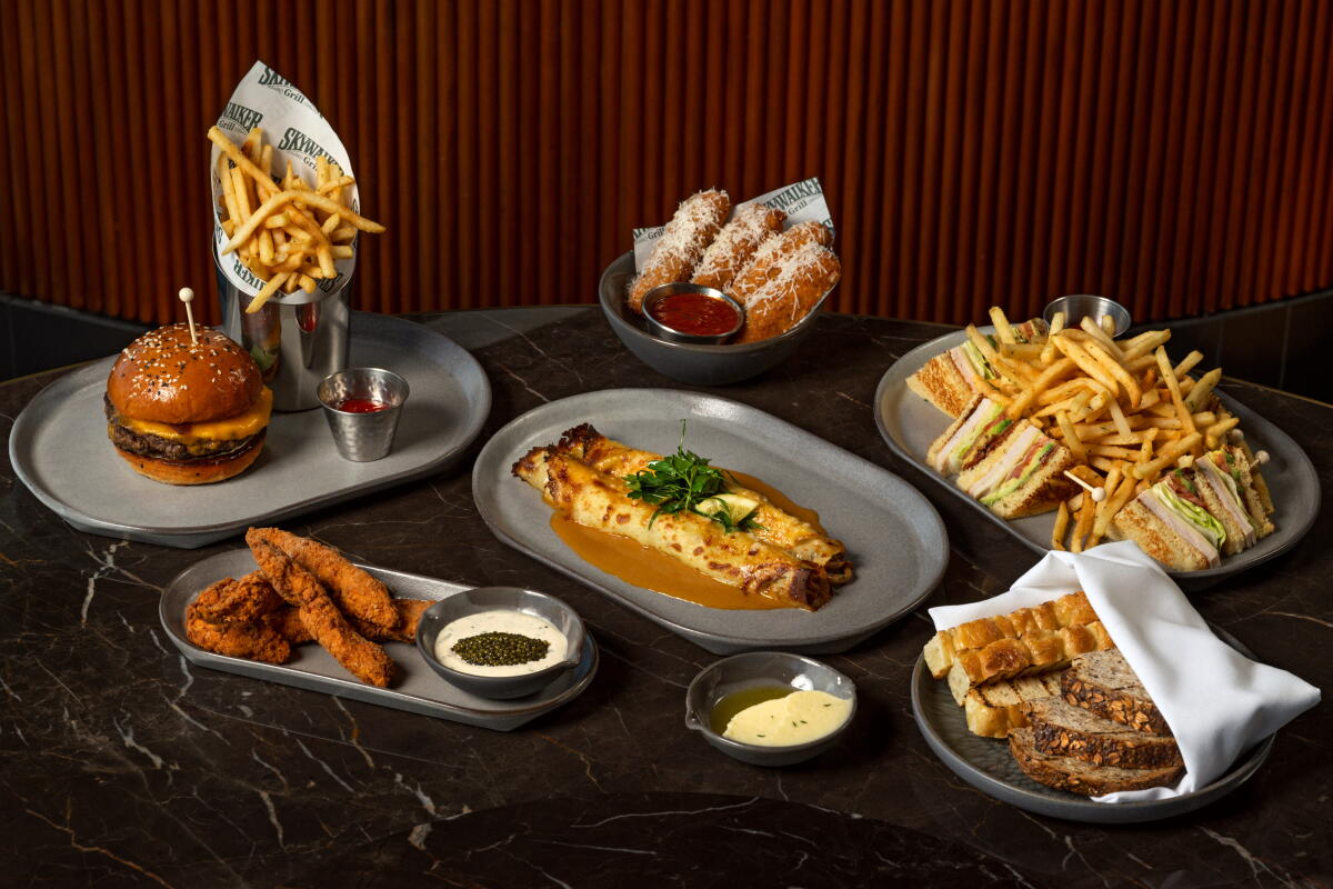 A burger, mozzarella sticks, a chicken-and-mushroom crêpe, a club sandwich, chicken tenders with caviar, and bread service.
