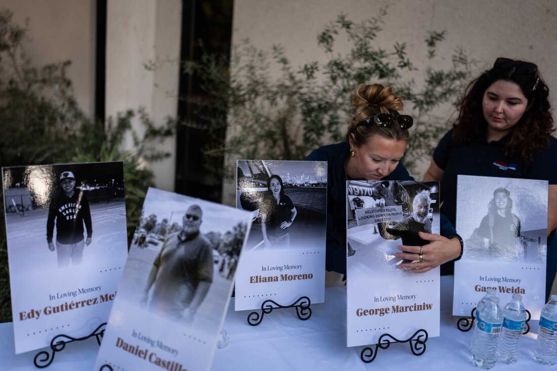 Savannah Sampson, right, and Nicole Lewis, help set up a vigil for the victims of Tuesday's fatal SUV-Metro bus collision and the subsequent crash of a TV news helicopter that was covering it in the Chatsworth neighborhood of Los Angeles, Thursday, Sept. 17, 2026.