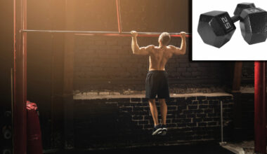 Gym bro doing pull-ups next to 25lb dumbbells used for lateral raise