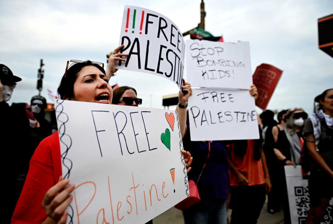 Pro-Palestinian demonstrators hold signs during a "Free Palestine" protest before an Ed Sheeran concert in Philadelphia, Saturday, Sept. 19, 2026.