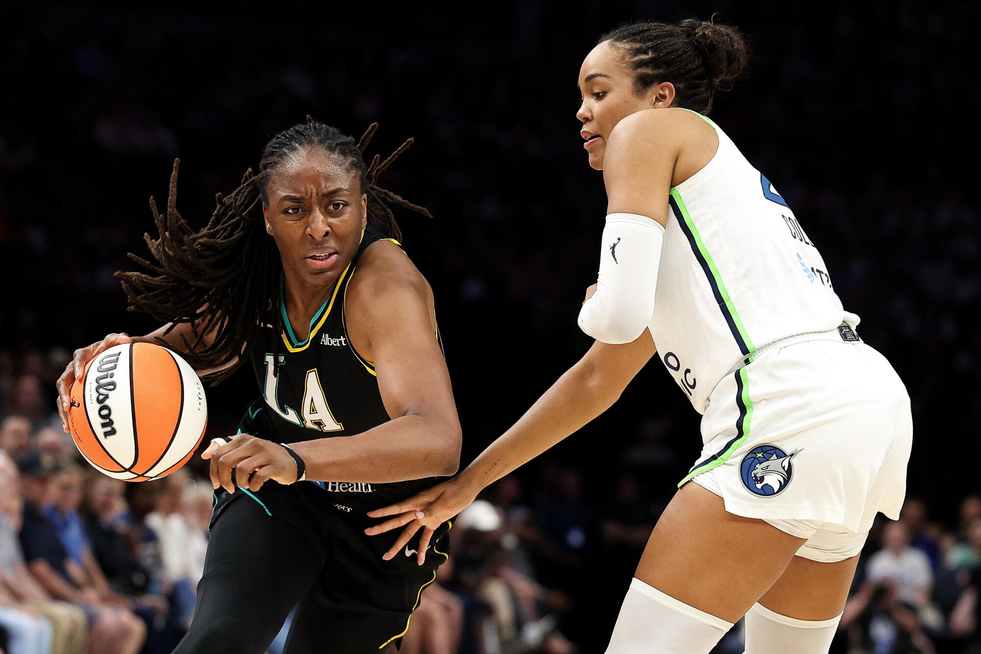 Sparks forward Nneka Ogwumike, left, tries to drive past Lynx forward Napheesa Collier.