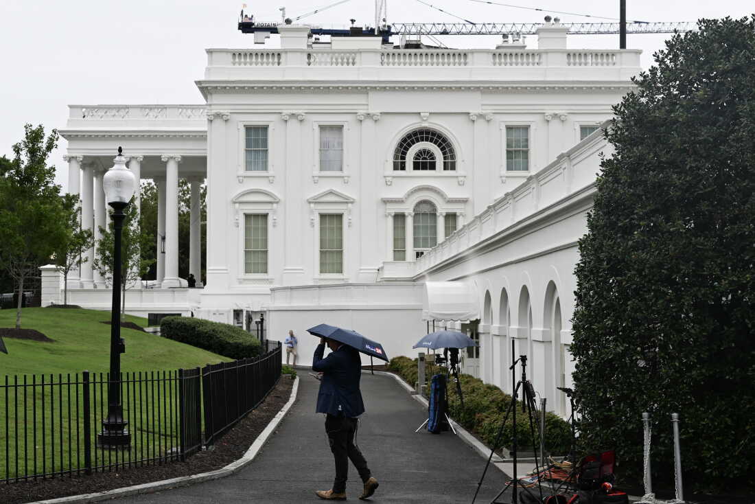 Members of the press are seen outside the White House in Washington, D.C., on Sept. 21.