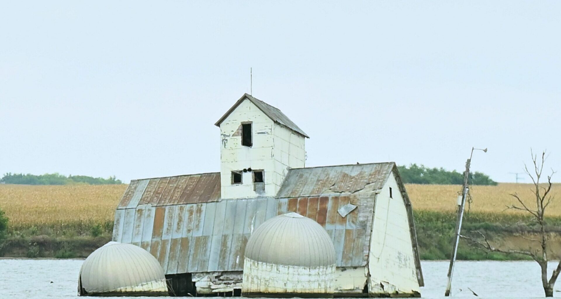 The barn and silos of the Reetz family farm sit in the middle of Reetz Lake. The buildings have become the centerpiece of Sunken Prairie Golf Club, scheduled to open in spring 2028 just south of Webster. Aberdeen Insider photo by Robb Garofalo.