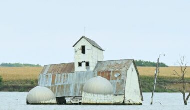 The barn and silos of the Reetz family farm sit in the middle of Reetz Lake. The buildings have become the centerpiece of Sunken Prairie Golf Club, scheduled to open in spring 2028 just south of Webster. Aberdeen Insider photo by Robb Garofalo.