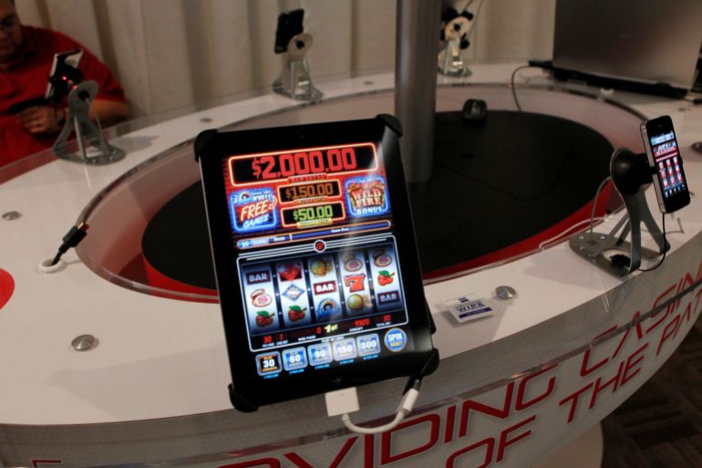 San Manuel Indian Bingo and Casino's online gambling app "Code Red" is demonstrated in the exhibitors room at the GiGse online gaming convention at the Westin hotel in San Francisco, California, April 24, 2012. Online poker is a business that involves processing billions of dollars worth of bets and battling the fraudsters, cheats and robot-player software that can ruin the games. Hence the casinos are cozying up to some tech-savvy offshore partners whose pedigrees might give regulators pause. Photo taken April 24, 2012. To match Special Report USA-POKER/GAMBLING REUTERS/Beck Diefenbach (UNITED STATES - Tags: BUSINESS ENTERTAINMENT)