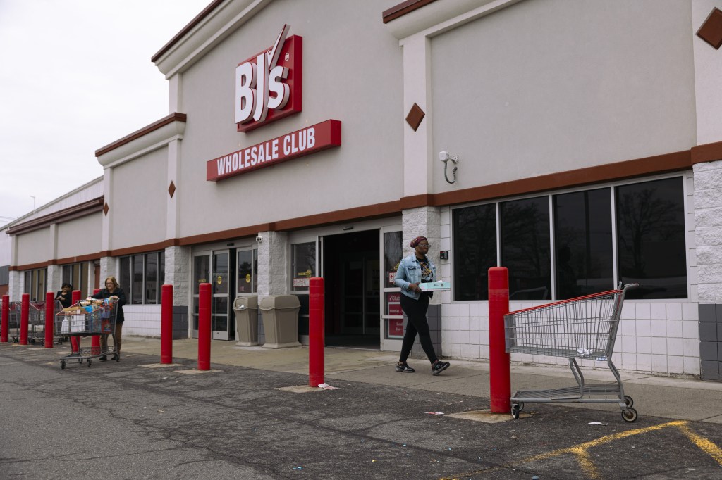 BJ's Wholesale Club in Albany, New York, with customers and shopping carts outside.