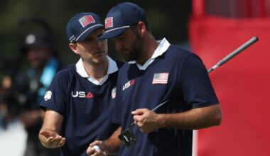 Golf - The 2025 Ryder Cup - Bethpage Black Golf Course, Farmingdale, New York, United States - September 27, 2025 Team USA's Russell Henley and Team USA's Scottie Scheffler react on the 18th green during the foursomes REUTERS/Paul Childs