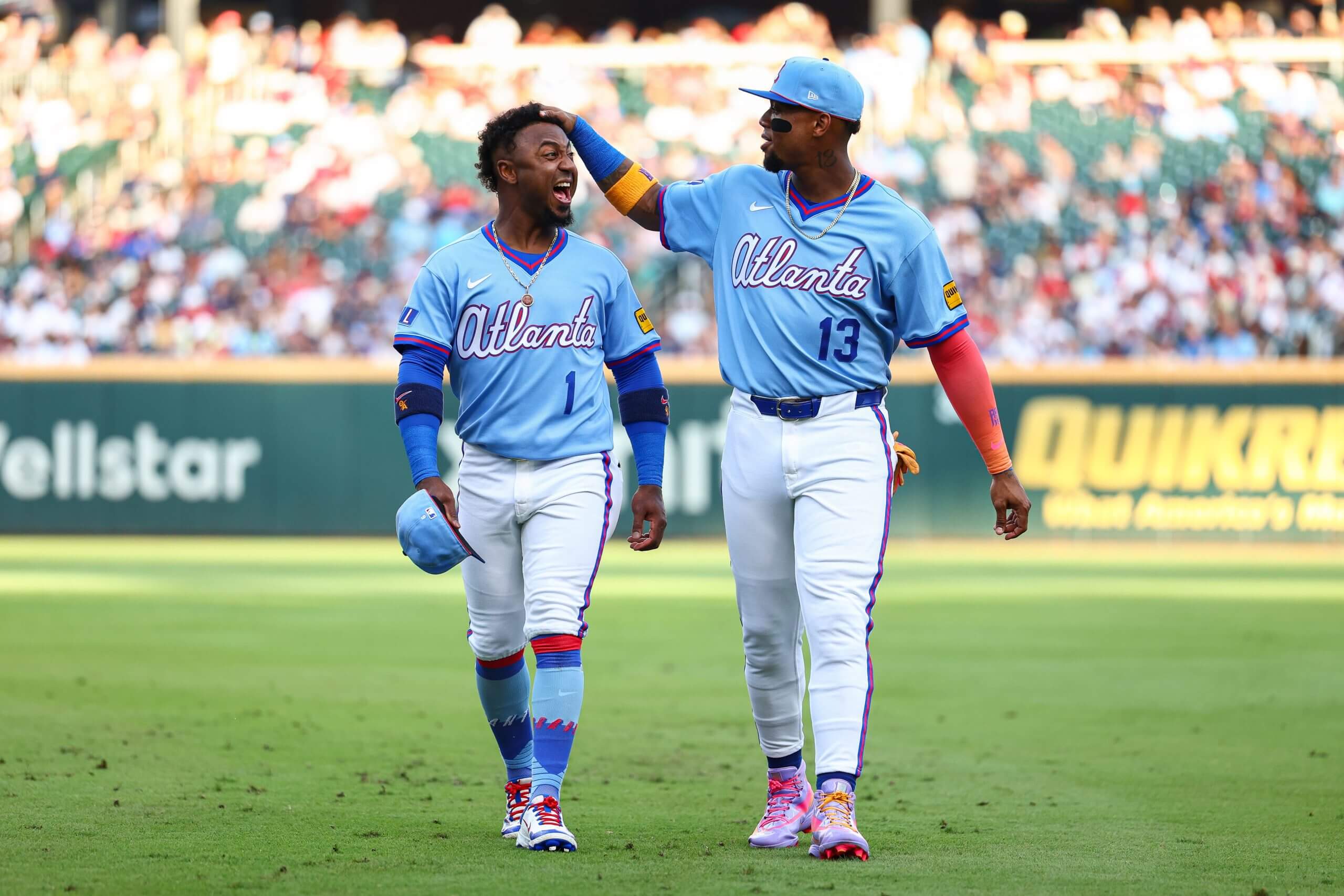 Atlanta Braves second baseman Ozzie Albies and right fielder Ronald Acuña Jr. react before a game against the Arizona Diamondbacks at Truist Park.