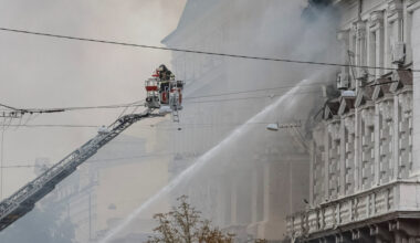 Firefighters work at a site of a building of the headquarters of Ukraine's SBU security service after a Russian drone stri...
