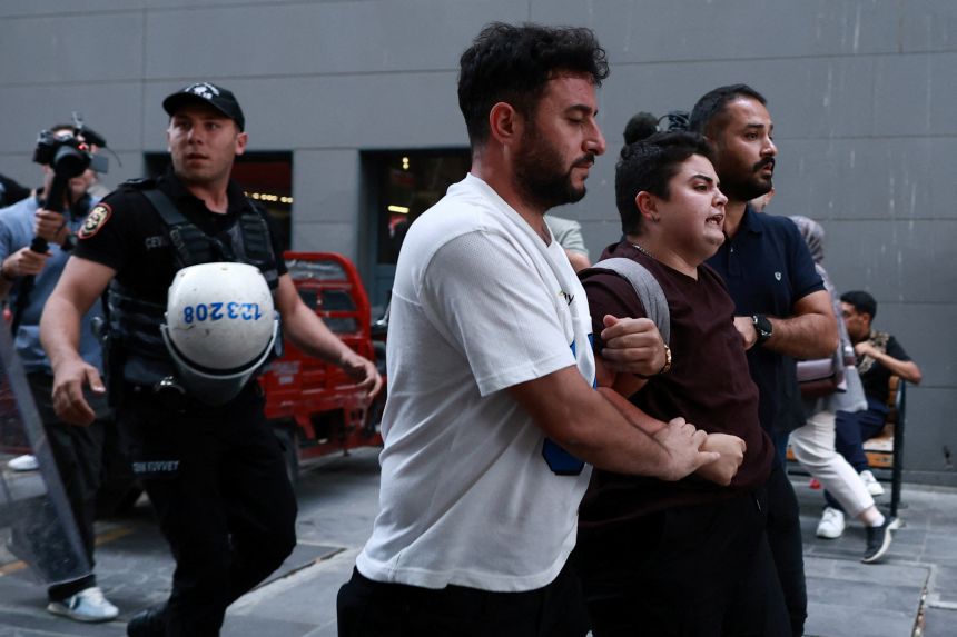 Plainclothes police officers detain a protester during a demonstration held in solidarity with the LGBTQ+ community and against government raids on LGBTQ+ groups, in Ankara, Turkey, on September 15.