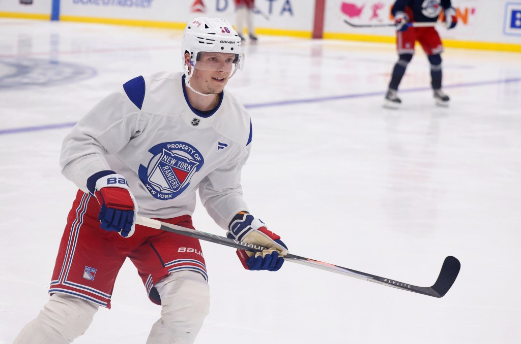 A New York Rangers player in practice gear on the ice.