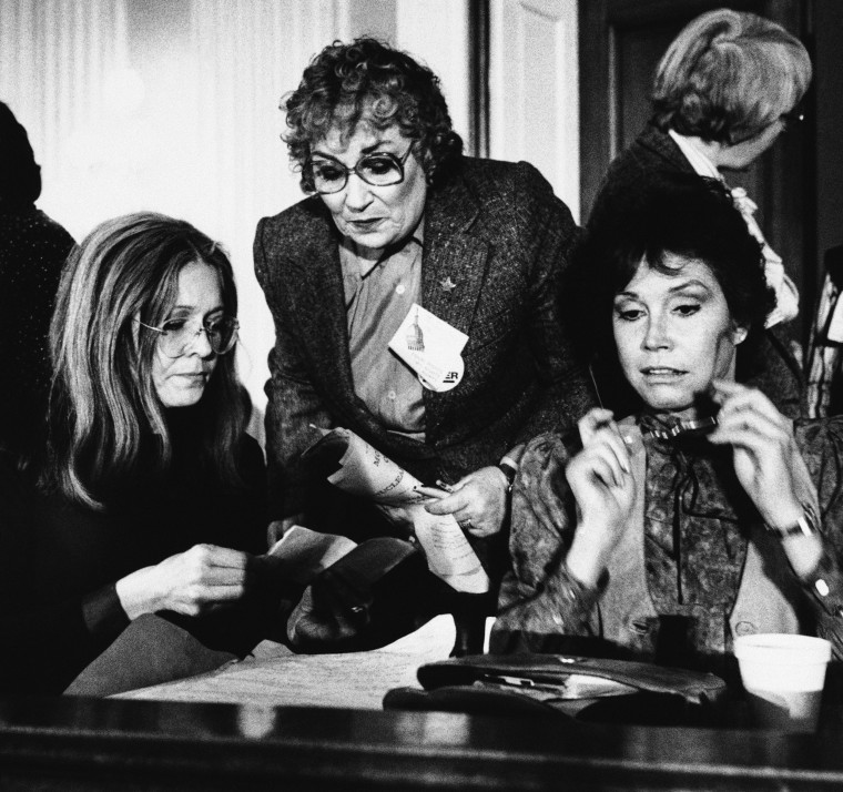 Gloria Steinem, left, joins former Congresswoman Bella Abzug and actress Mary Tyler Moore, right, during a meeting of women’s rights leaders on Capitol Hill on Feb. 4, 1981.