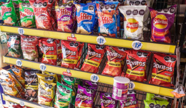 Shelves stocked with assorted bags of Mexican chips, including Ruffles, Sabritas, and Doritos, in various colorful packaging, with some Pringles cans at the bottom.