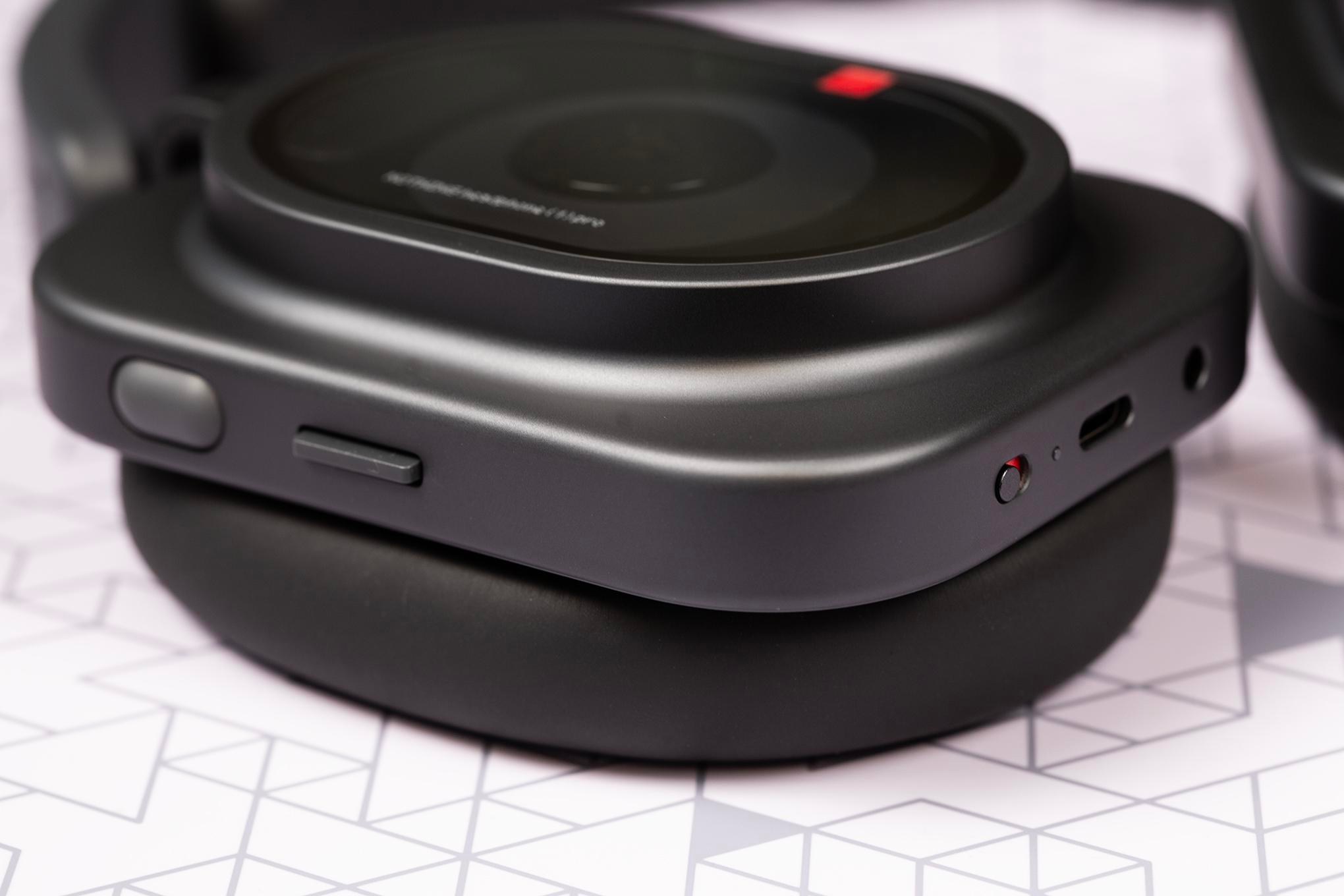 Macro shot of button and ports on a pair of Nothing Pro 1 headphones.